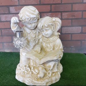 Boy and girl reading a book solar light